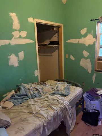 a bedroom with a bed and a mirror