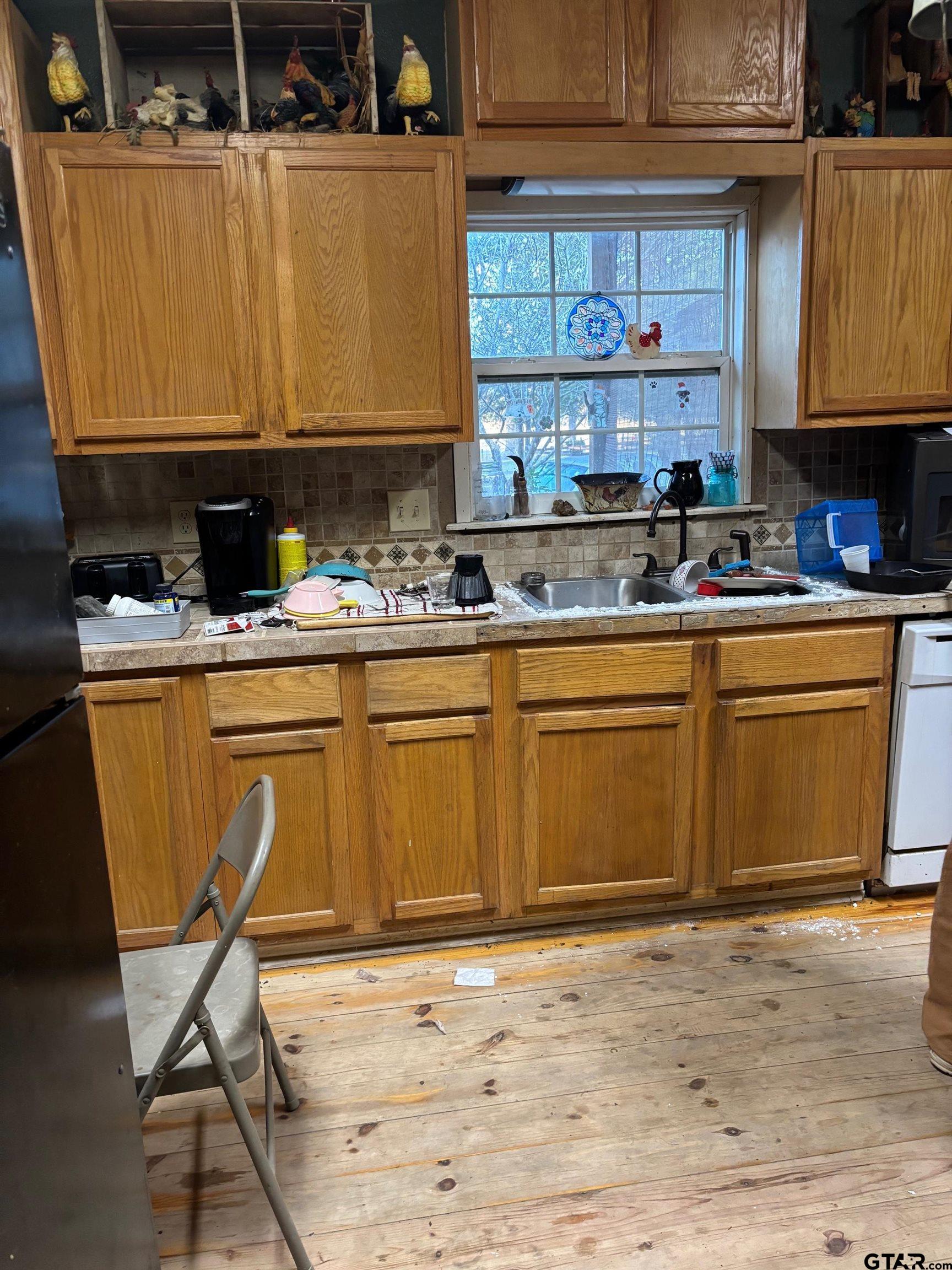 10748 Highway 84 Rusk, TX 75785 - Photo 5 of 15 a kitchen with stainless steel appliances granite countertop a stove a sink and a microwave