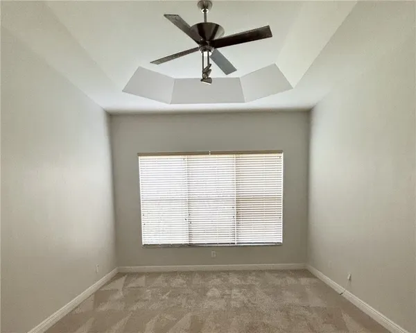 a view of a hallway to an empty room and fire place
