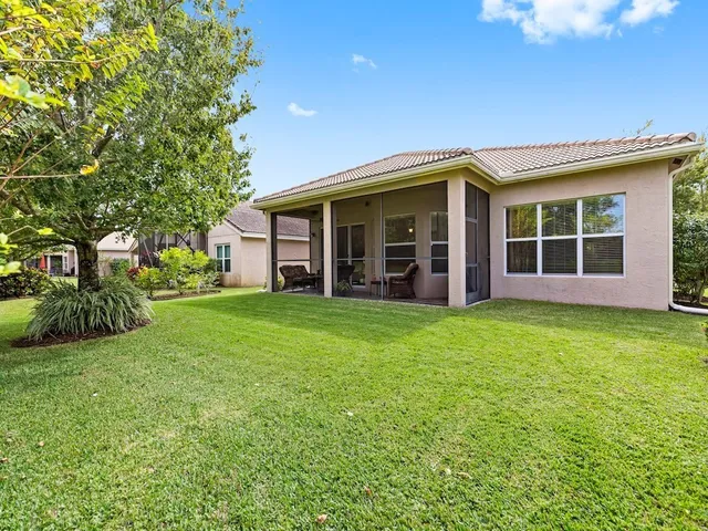 an aerial view of residential houses with outdoor space and swimming pool