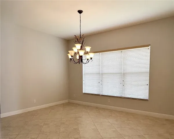 a view of a room with window and kitchen view