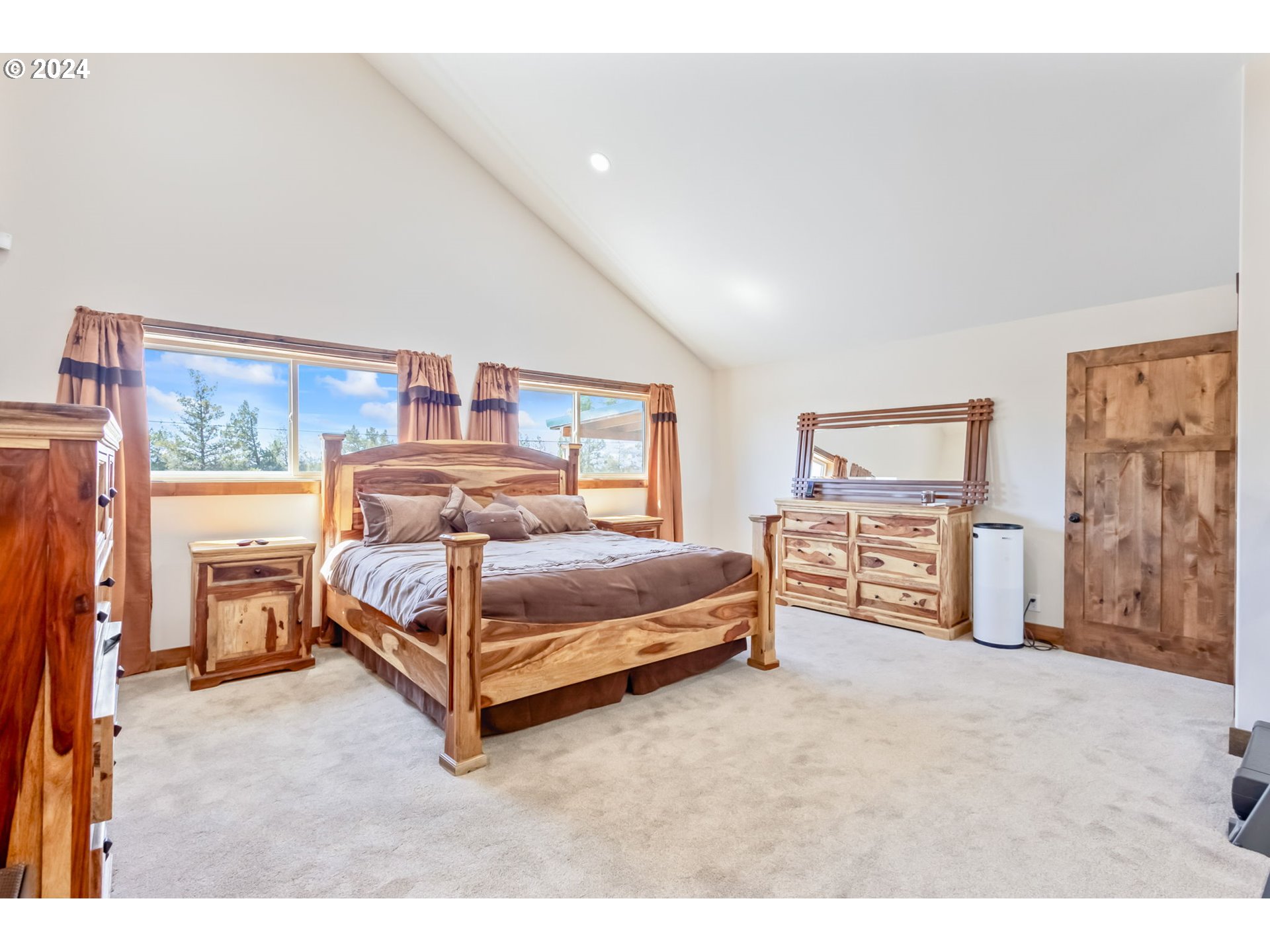3068 Southwest Reif Road Powell Butte, OR 97753 - Photo 13 of 42 a bedroom with a bed and a large window