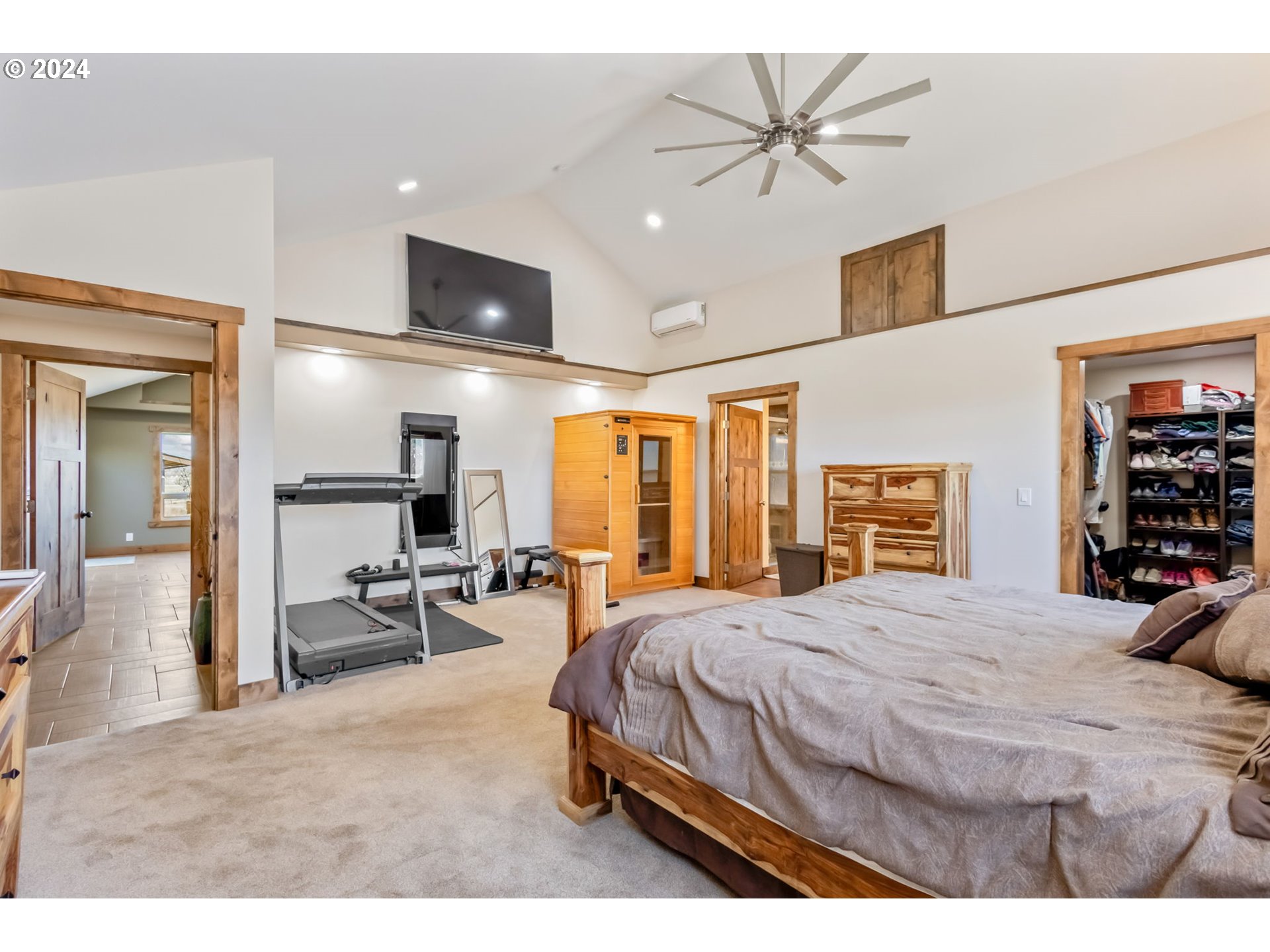 3068 Southwest Reif Road Powell Butte, OR 97753 - Photo 14 of 42 a bedroom with a bed a table and chair with the large mirror