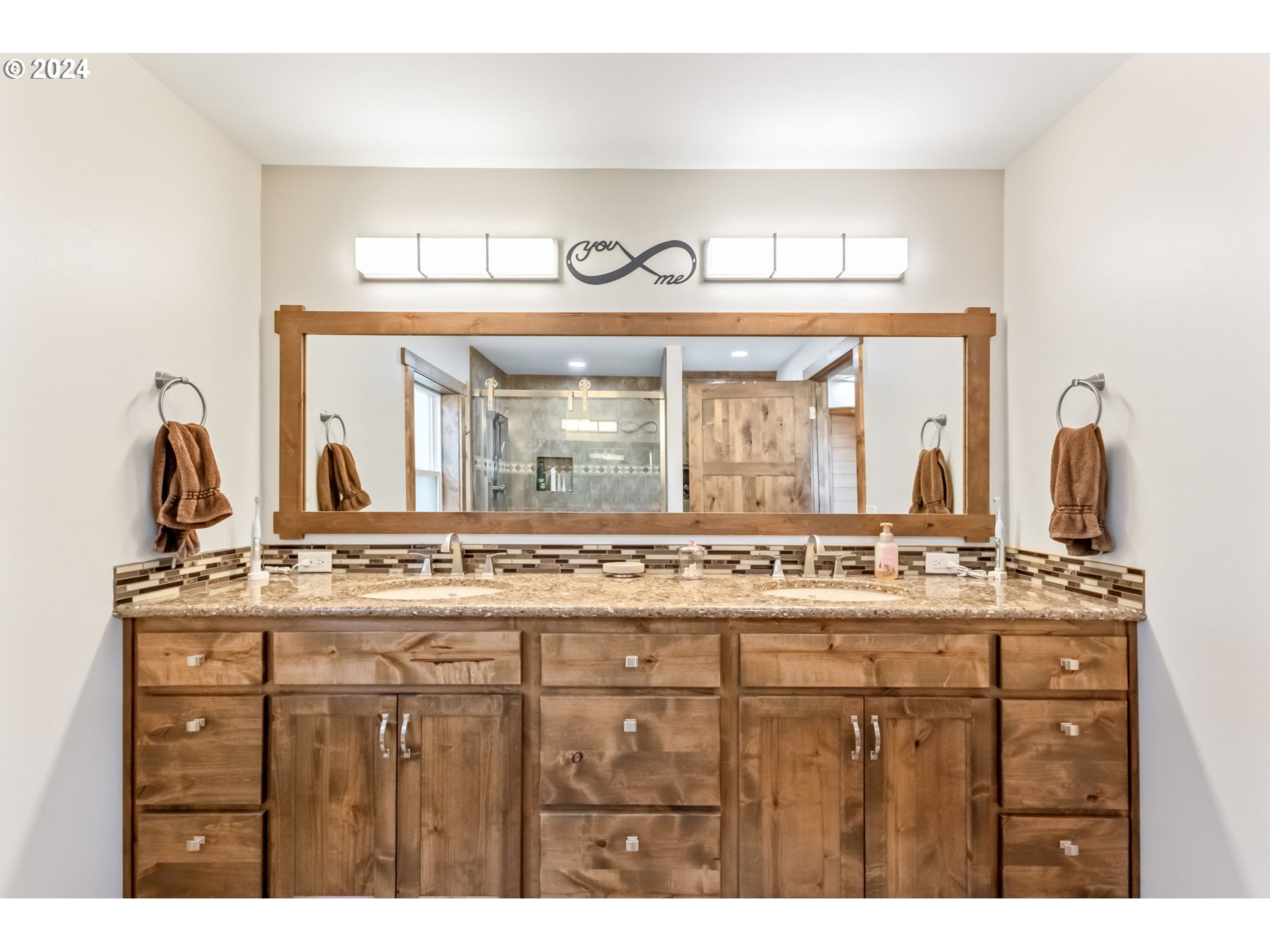 3068 Southwest Reif Road Powell Butte, OR 97753 - Photo 16 of 42 a bathroom with a sink a mirror and a shower