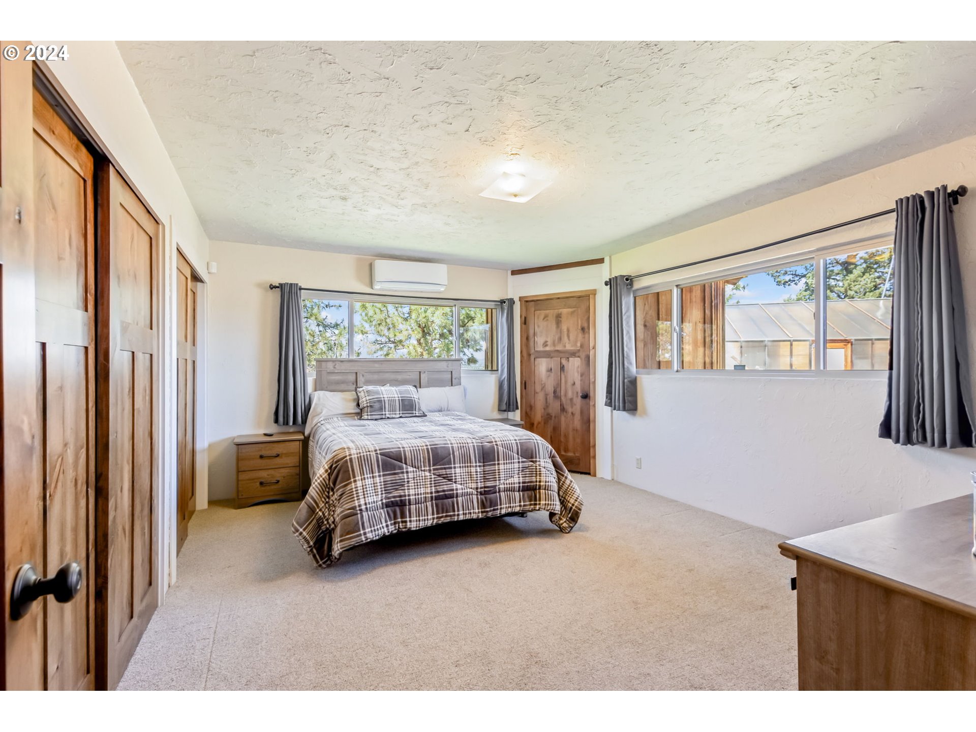 3068 Southwest Reif Road Powell Butte, OR 97753 - Photo 20 of 42 a bedroom with a large bed and a window