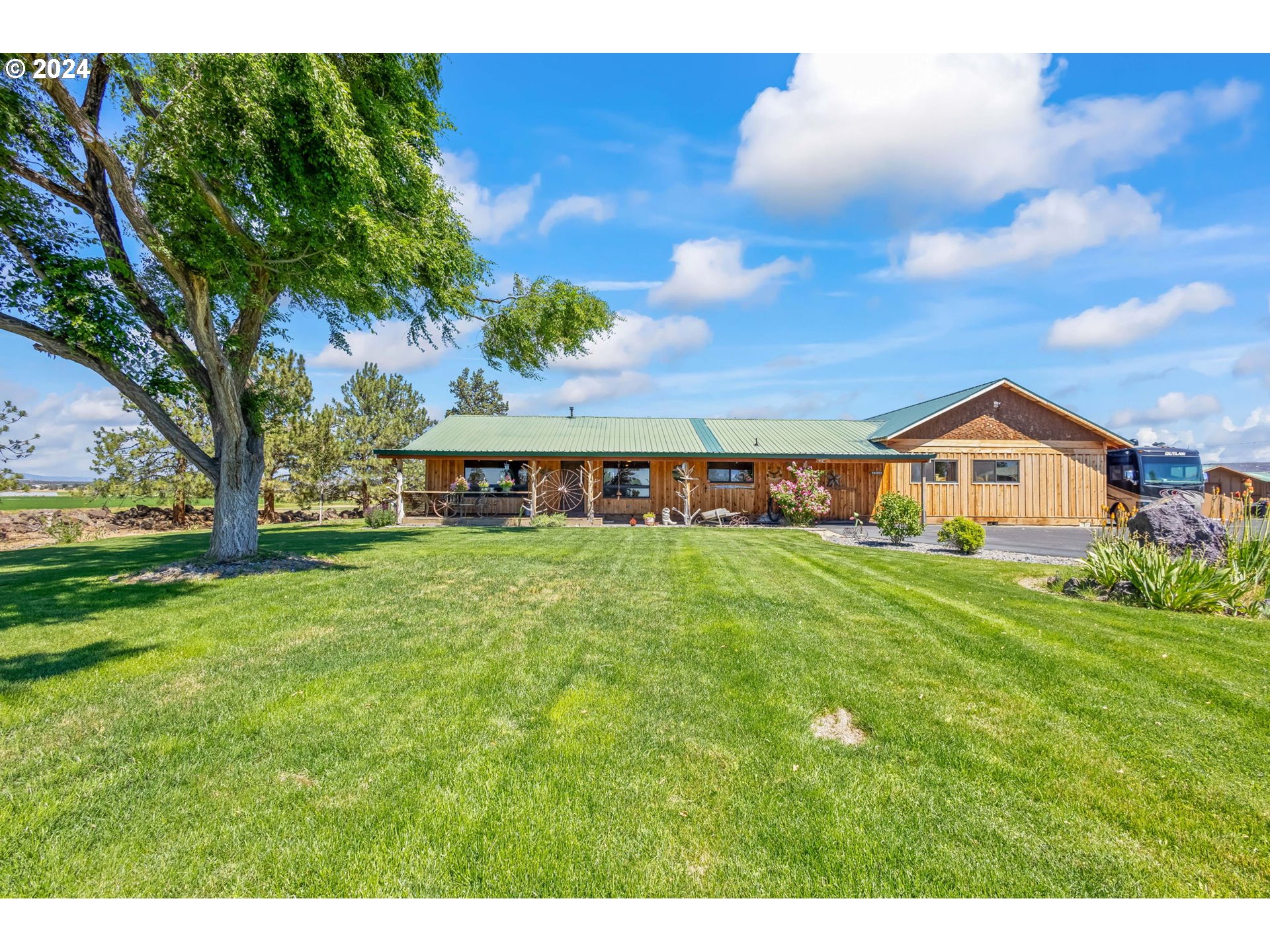 3068 Southwest Reif Road Powell Butte, OR 97753 - Photo 2 of 42 a front view of house with yard and seating