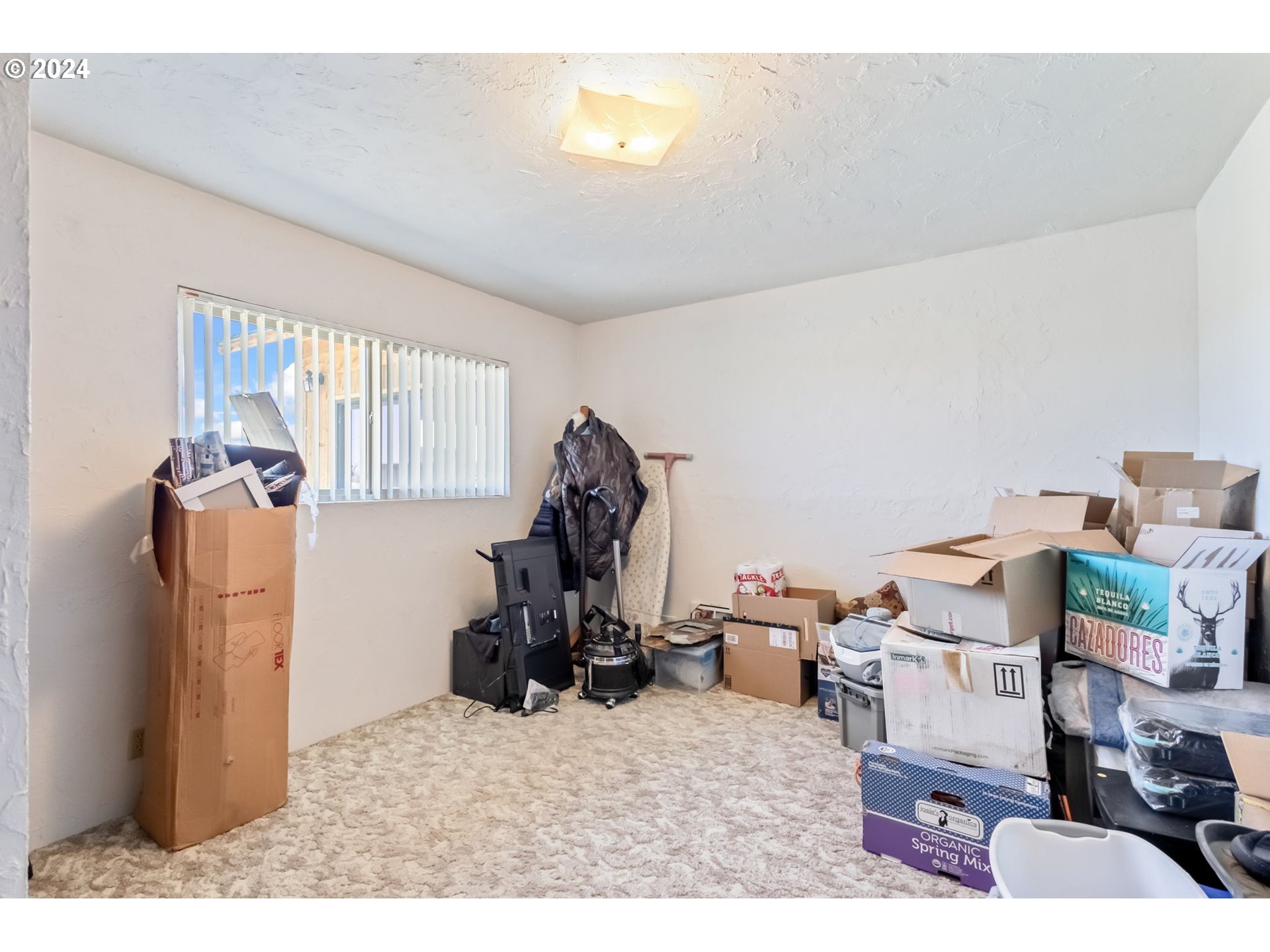 3068 Southwest Reif Road Powell Butte, OR 97753 - Photo 21 of 42 a living room with furniture a window and gym equipment