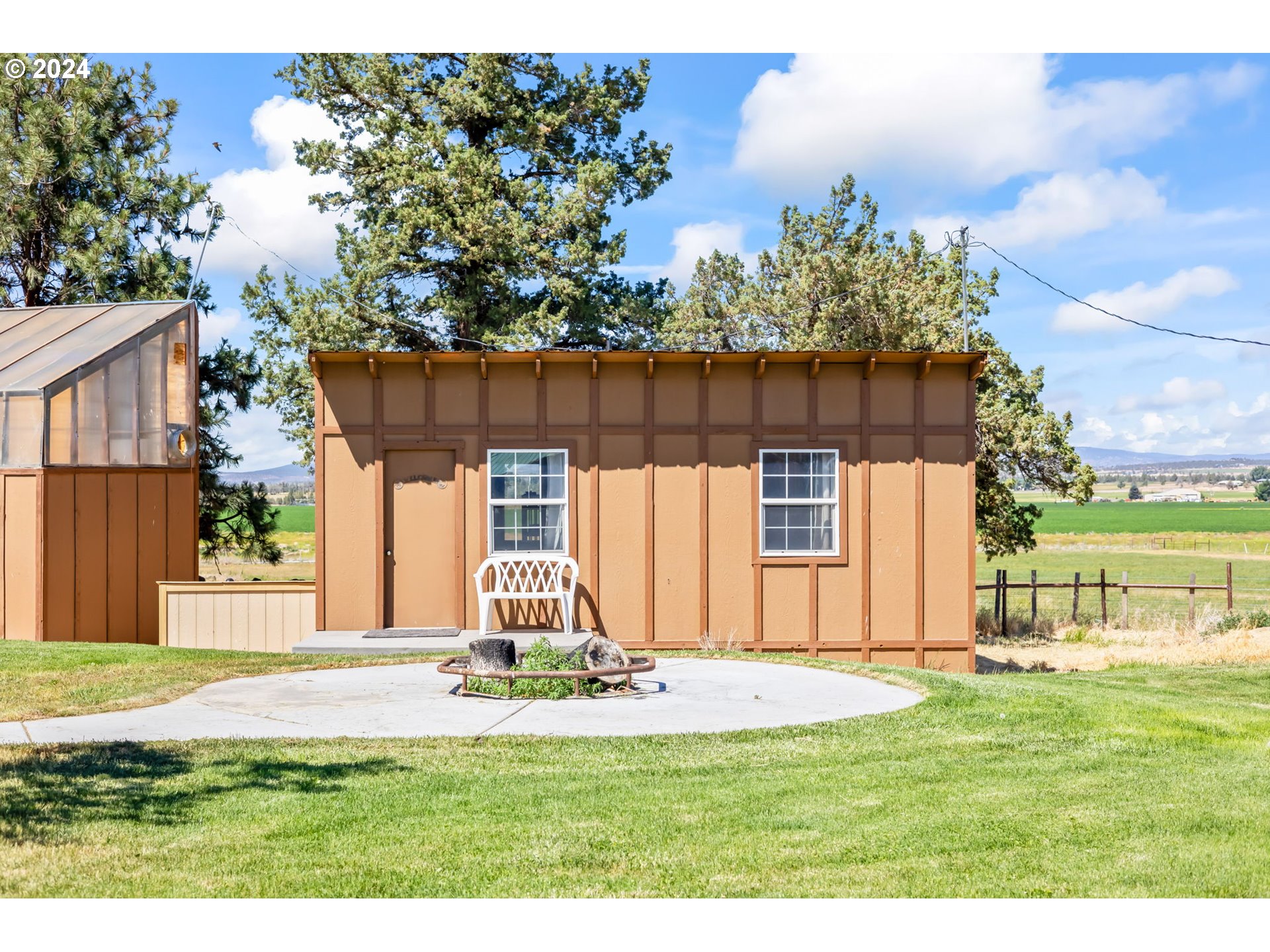 3068 Southwest Reif Road Powell Butte, OR 97753 - Photo 30 of 42 a front view of a house with garden