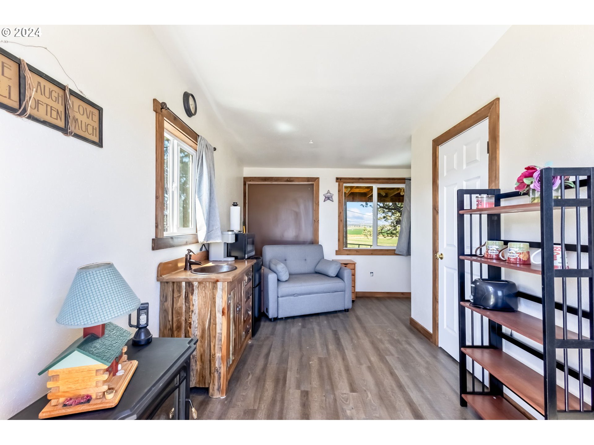 3068 Southwest Reif Road Powell Butte, OR 97753 - Photo 31 of 42 a living room with furniture and a wooden floor