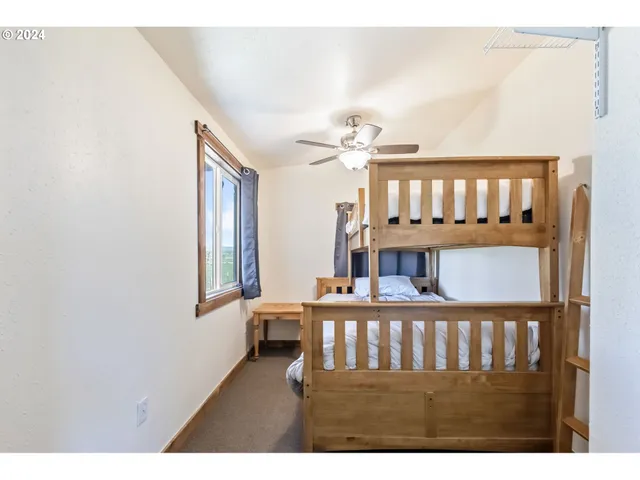 a view of a bedroom with furniture and window