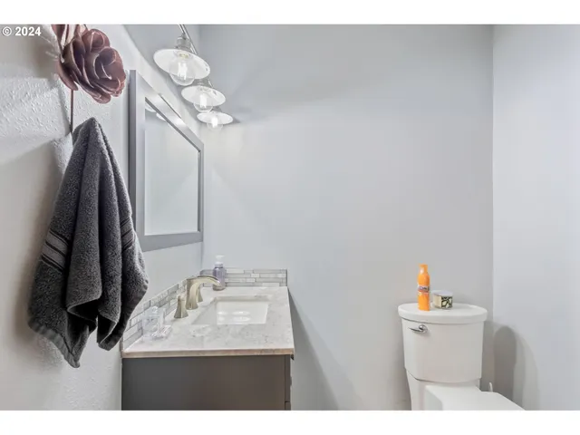 a bathroom with a sink vanity and a mirror