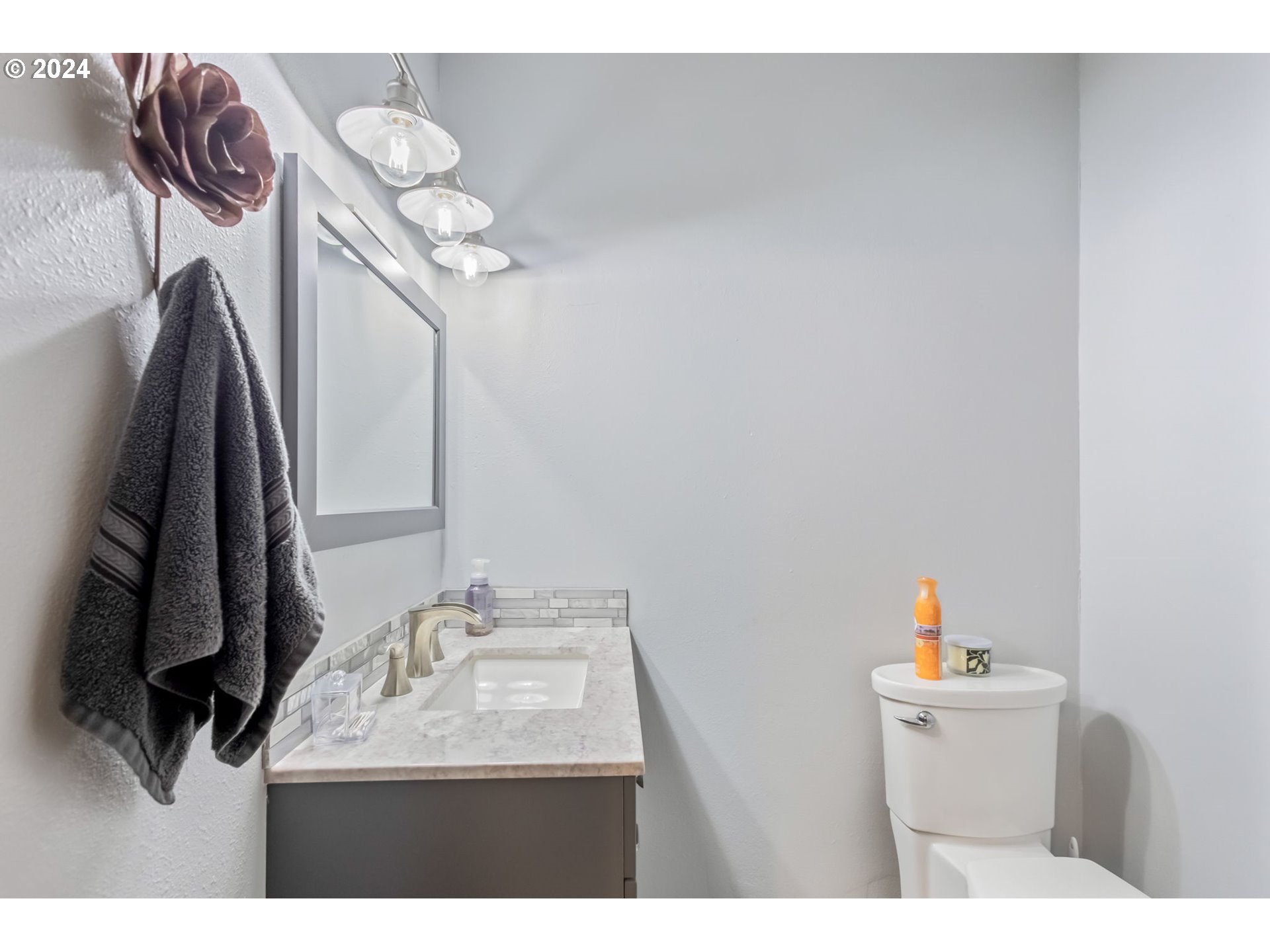 3068 Southwest Reif Road Powell Butte, OR 97753 - Photo 34 of 42 a bathroom with a sink vanity and a mirror