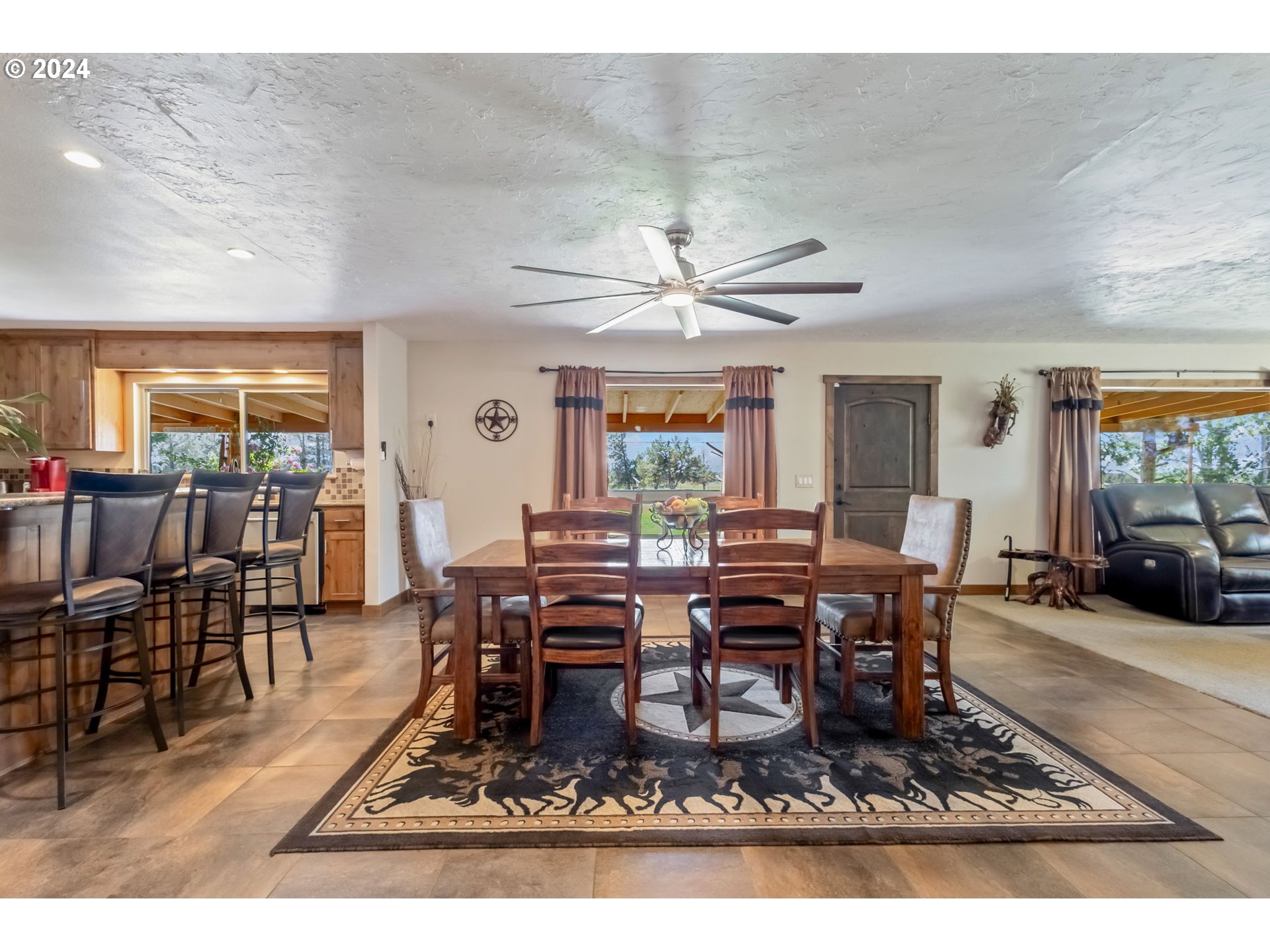 3068 Southwest Reif Road Powell Butte, OR 97753 - Photo 6 of 42 a living room with furniture a dining table and a piano table