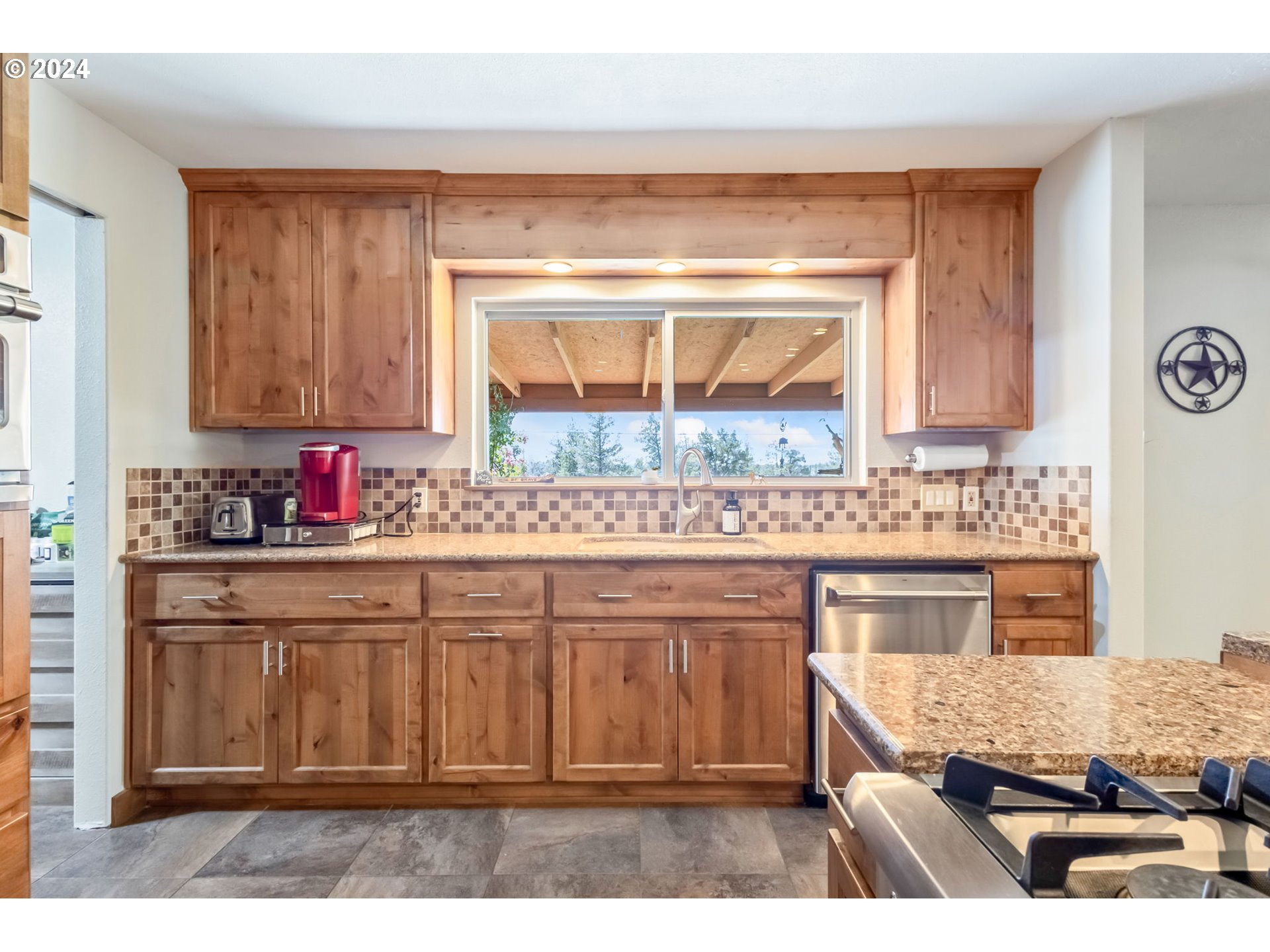 3068 Southwest Reif Road Powell Butte, OR 97753 - Photo 8 of 42 a kitchen with a sink stove and cabinets