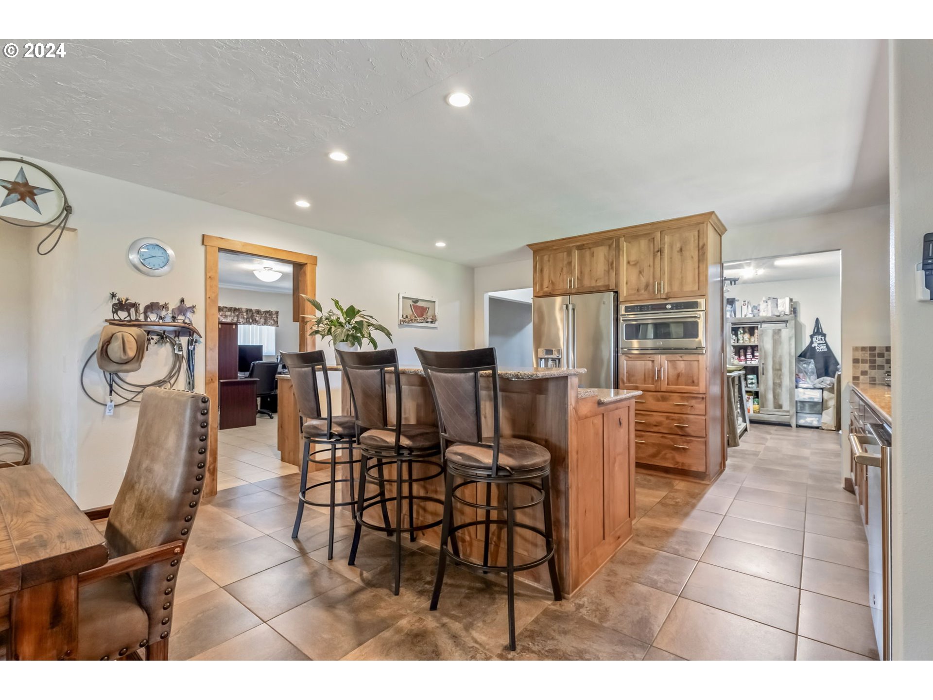 3068 Southwest Reif Road Powell Butte, OR 97753 - Photo 9 of 42 a dining area with furniture and kitchen view