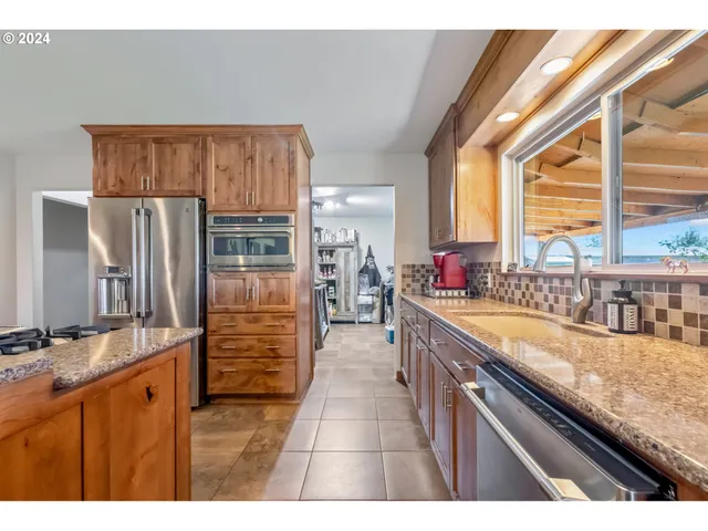 a kitchen with granite countertop a refrigerator and a sink