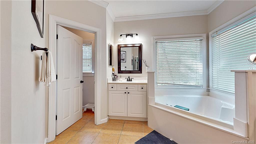 3234 Rhett Butler Place Charlotte, NC 28270 - Photo 14 of 27 a bathroom with a tub sink and mirror