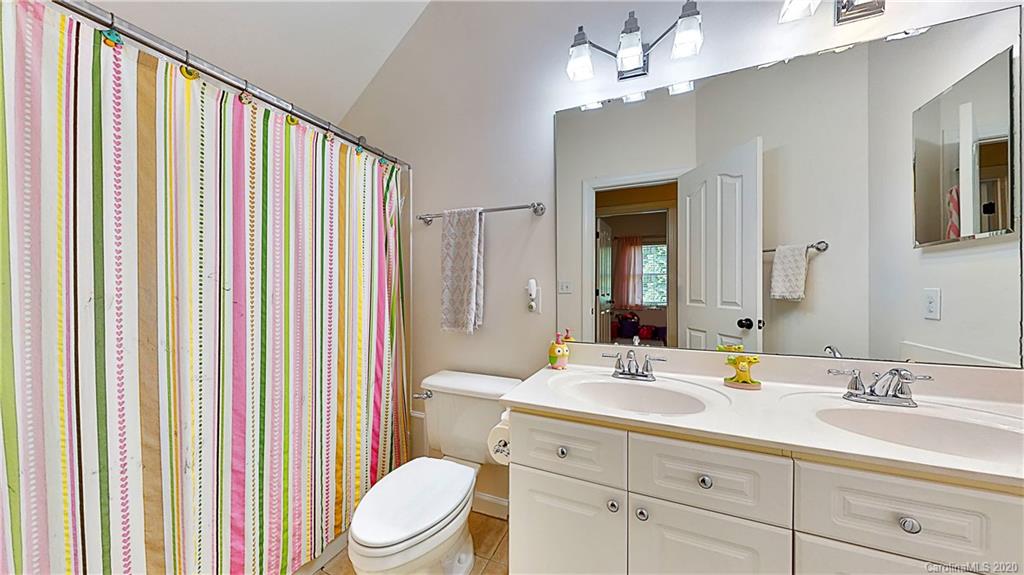 3234 Rhett Butler Place Charlotte, NC 28270 - Photo 16 of 27 a bathroom with a sink a toilet and shower curtain