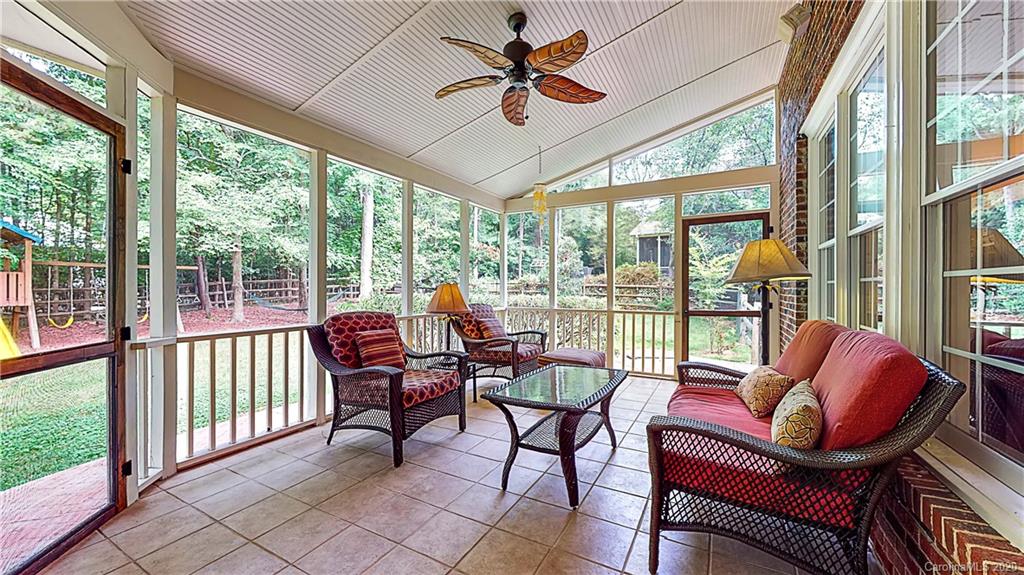 3234 Rhett Butler Place Charlotte, NC 28270 - Photo 21 of 27 a living room with furniture and a floor to ceiling window