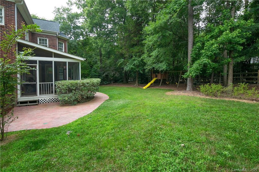 3234 Rhett Butler Place Charlotte, NC 28270 - Photo 25 of 27 a front view of a house with garden and trees