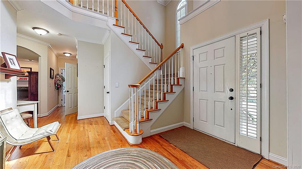 3234 Rhett Butler Place Charlotte, NC 28270 - Photo 4 of 27 a view of a livingroom with wooden floor and staircase