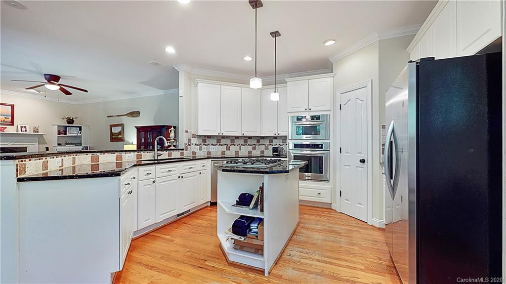 3234 Rhett Butler Place Charlotte, NC 28270 - Photo 6 of 27 a kitchen with stainless steel appliances granite countertop a refrigerator and a stove top oven