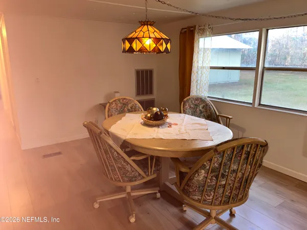 a dining room with furniture and a window