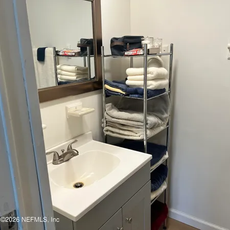 a bathroom with a sink and mirror