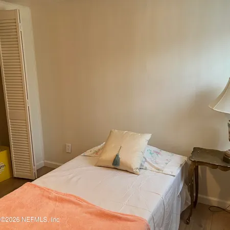 a bedroom with a bed and a night stand