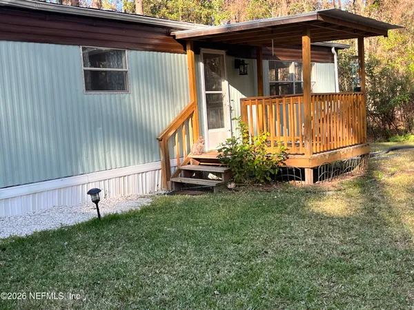 a view of backyard with deck and garden