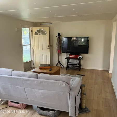 a living room with furniture and a flat screen tv