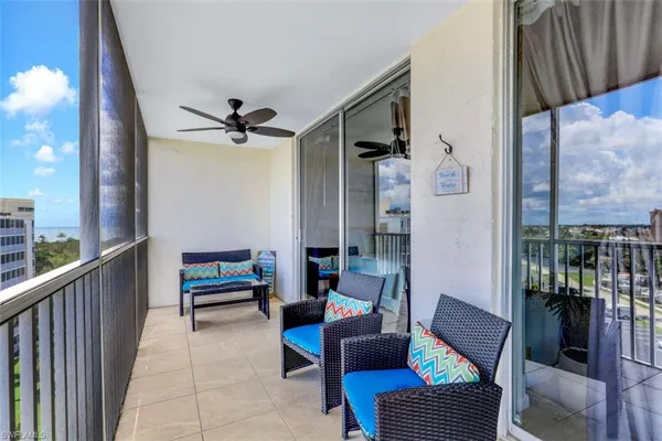 a living room with furniture a ceiling fan and a rug