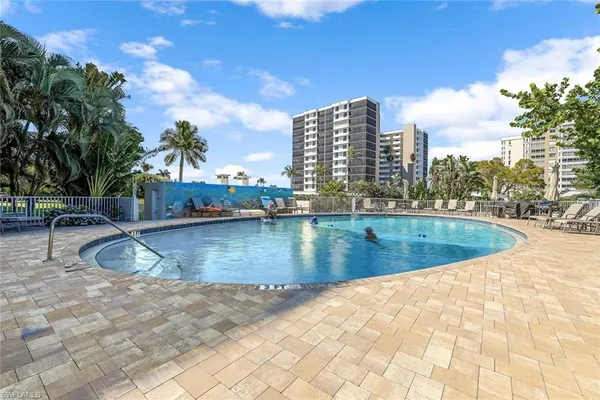 a view of swimming pool with outdoor seating