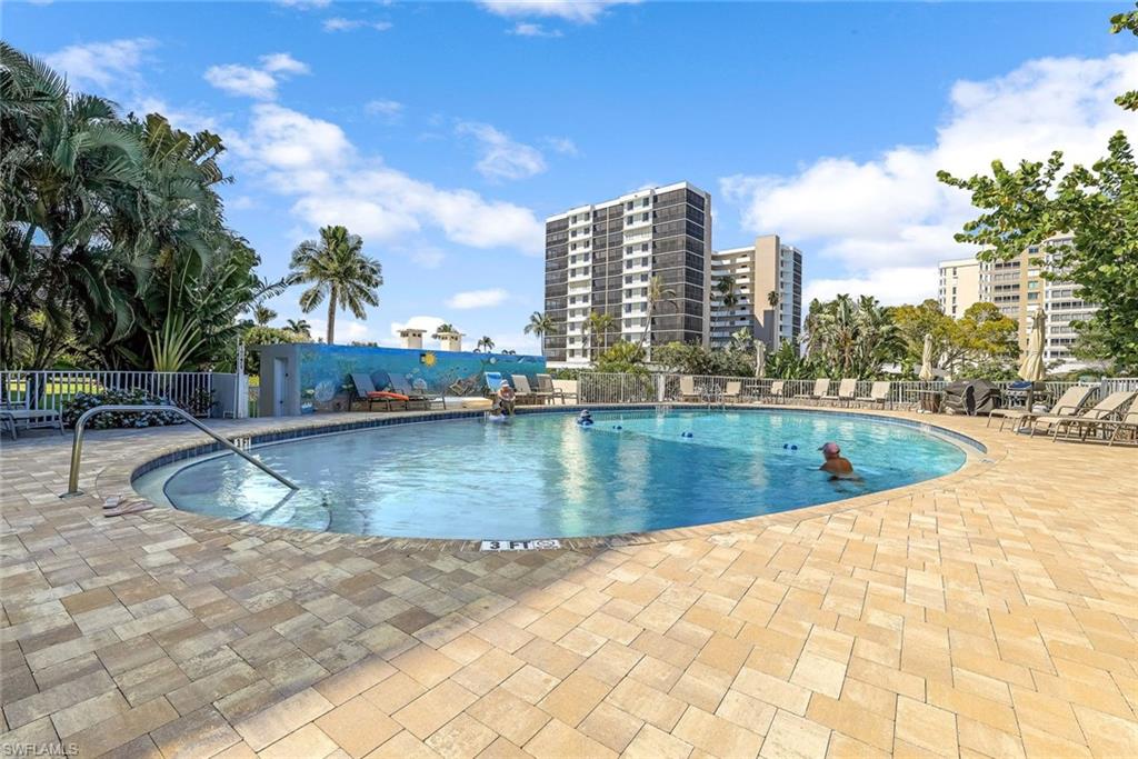 5 Bluebill Avenue, Unit 810 Naples, FL 34108 - Photo 18 of 19 a view of swimming pool with outdoor seating and plants
