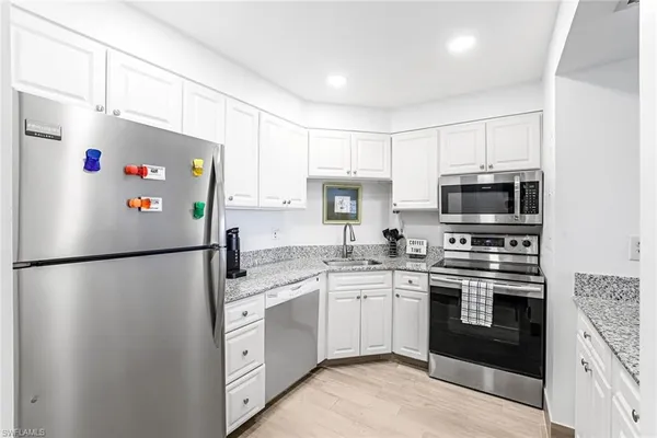 a white refrigerator freezer sitting in a kitchen