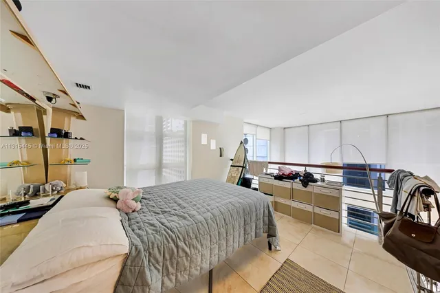 a bedroom with a bed a couch and dresser