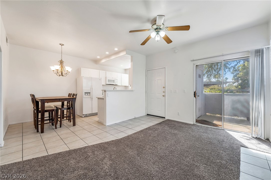2201 Ramsgate Drive, Unit 811 Henderson, NV 89074 - Photo 5 of 36 An open concept living area features a clean aesthetic, connecting the kitchen, dining, and living spaces.
