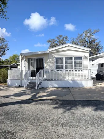 a view of a house with backyard and porch