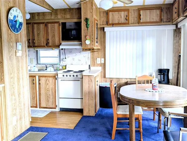 a kitchen with a table and chairs
