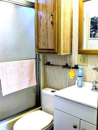 a bathroom with a sink a toilet and a window