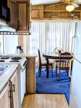 a view of a dining room with furniture and a window