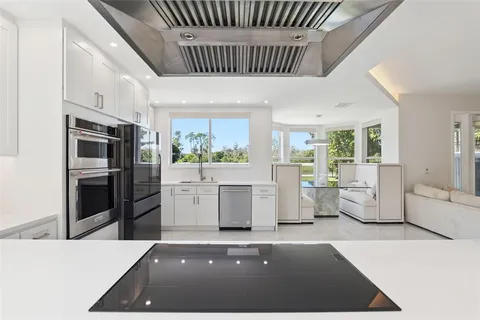 a kitchen with refrigerator and stove
