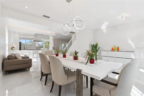 a view of a dining room with furniture and a chandelier