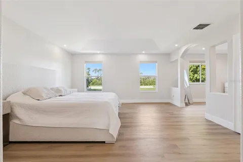 a spacious bedroom with a bed and window