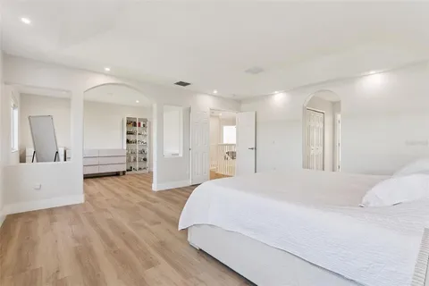 a spacious bedroom with a bed and a walk in closet