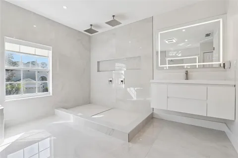 a large white bed in a white room