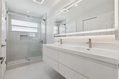 a bathroom with a shower and a sink