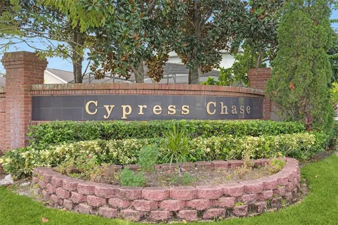 a sign that is sitting in front of flowers