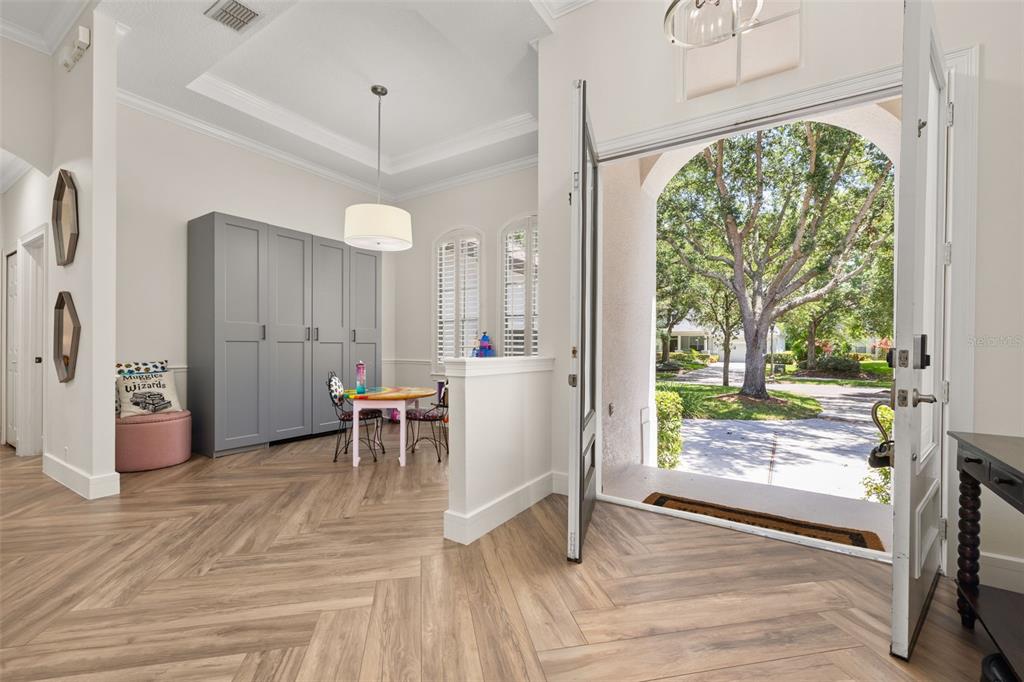 8351 Bowden Way Windermere, FL 34786 - Photo 6 of 71 a dining room with wooden floor and a floor to ceiling window
