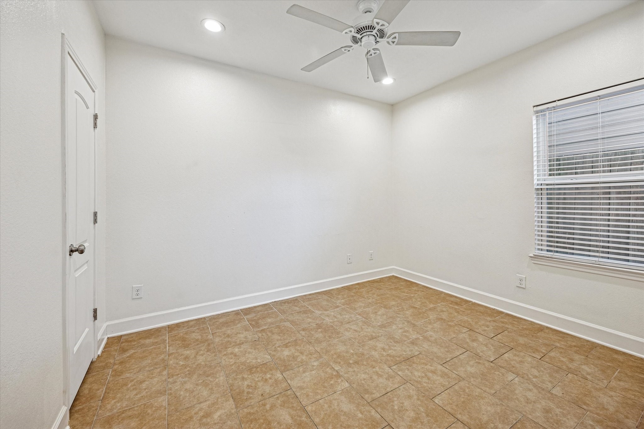 5402 Jonathan Lane Houston, TX 77011 - Photo 21 of 33 Enjoy the convenience of a bright and versatile first-floor room with a private en suite full bathroom, perfect for easy living.